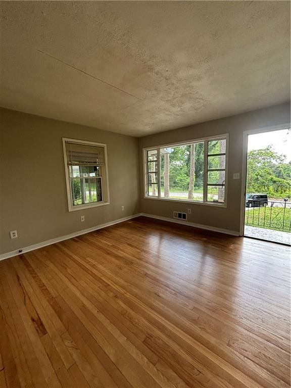 2069 Bixler Cir, Decatur, GA 30032 - unfurnished room with baseboards, a textured ceiling, and hardwood / wood-style floors