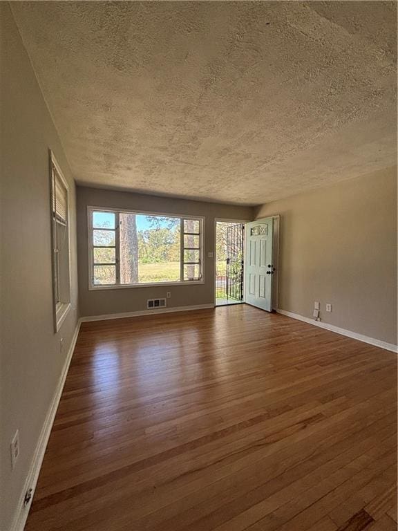 2069 Bixler Cir, Decatur, GA 30032 - unfurnished room featuring baseboards, dark wood-style flooring, and a textured ceiling