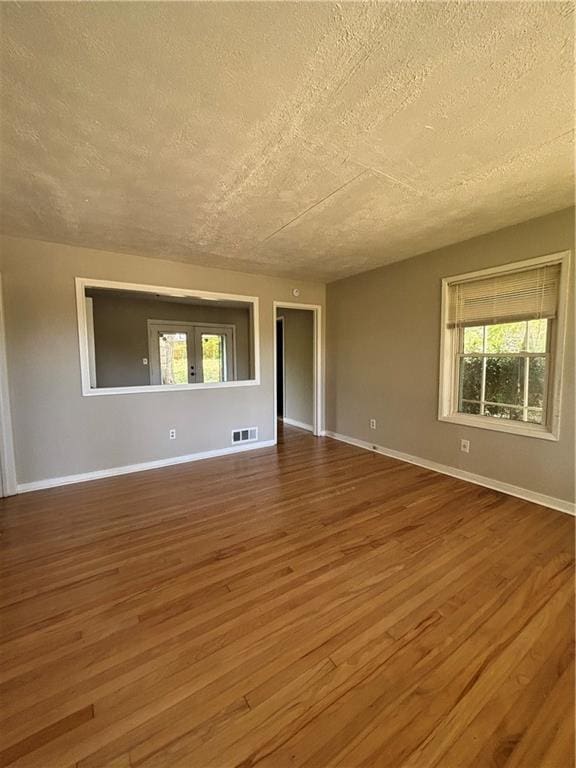 2069 Bixler Cir, Decatur, GA 30032 - spare room with visible vents, a textured ceiling, plenty of natural light, and wood finished floors