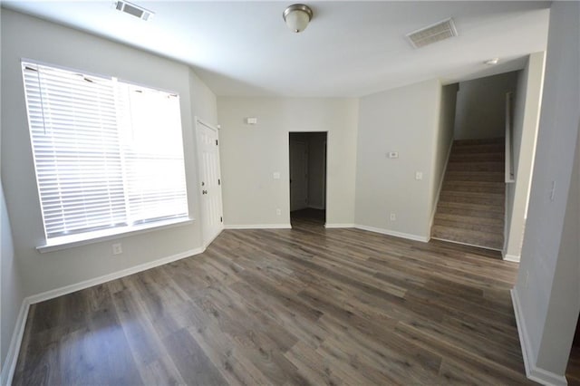 empty room with dark wood-type flooring