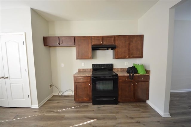 kitchen featuring black electric range oven and dark hardwood / wood-style floors