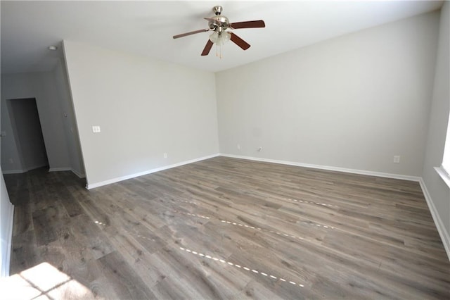 empty room with ceiling fan and dark wood-type flooring