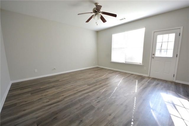 empty room with dark hardwood / wood-style floors and ceiling fan