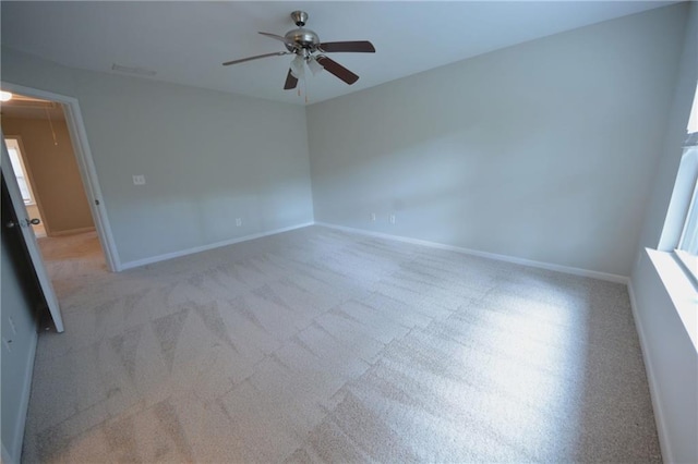 carpeted spare room with ceiling fan