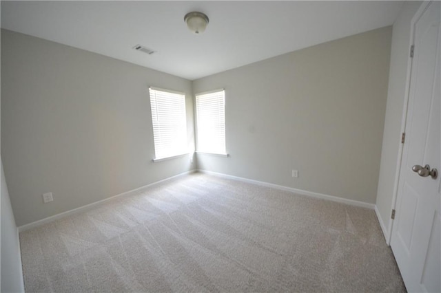 unfurnished room featuring light colored carpet