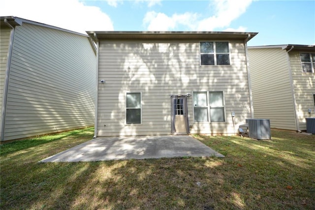 back of property featuring a patio area, a yard, and central AC