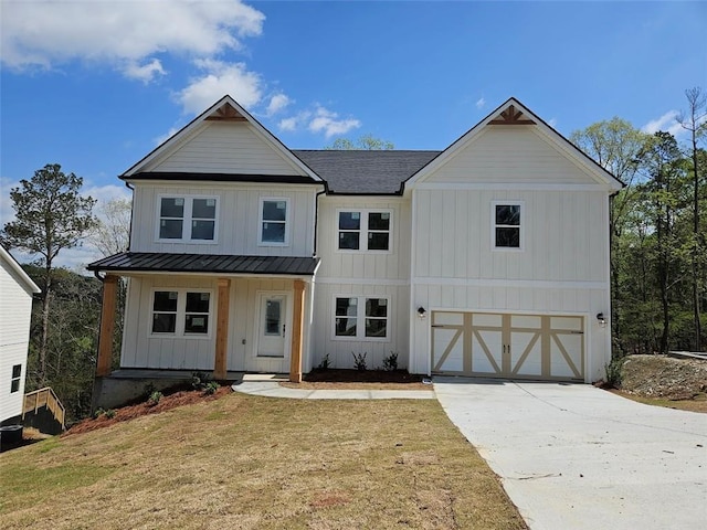 195 Silvercrest Dr, Acworth, GA 30101 - modern inspired farmhouse featuring board and batten siding, an attached garage, a standing seam roof, driveway, and covered porch