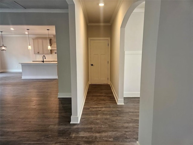 195 Silvercrest Dr, Acworth, GA 30101 - hall with dark wood-type flooring, arched walkways, ornamental molding, baseboards, and a sink