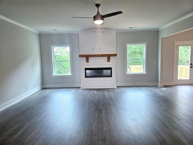 195 Silvercrest Dr, Acworth, GA 30101 - unfurnished living room featuring dark wood-type flooring, baseboards, ceiling fan, a fireplace, and crown molding