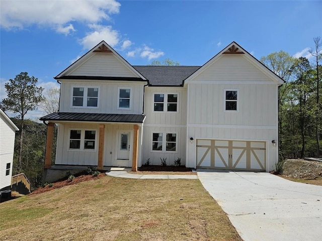 195 Silvercrest Dr, Acworth, GA 30101 - modern farmhouse featuring board and batten siding, a standing seam roof, covered porch, a garage, and driveway