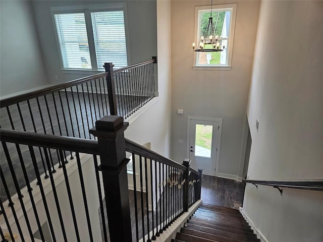 195 Silvercrest Dr, Acworth, GA 30101 - stairway with a chandelier, wood finished floors, and baseboards