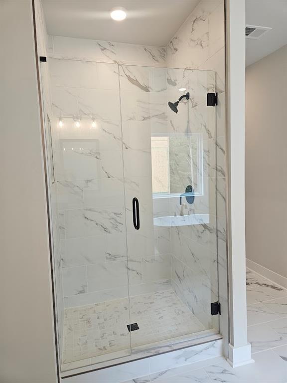 195 Silvercrest Dr, Acworth, GA 30101 - bathroom with marble look tile flooring, a marble finish shower, and baseboards