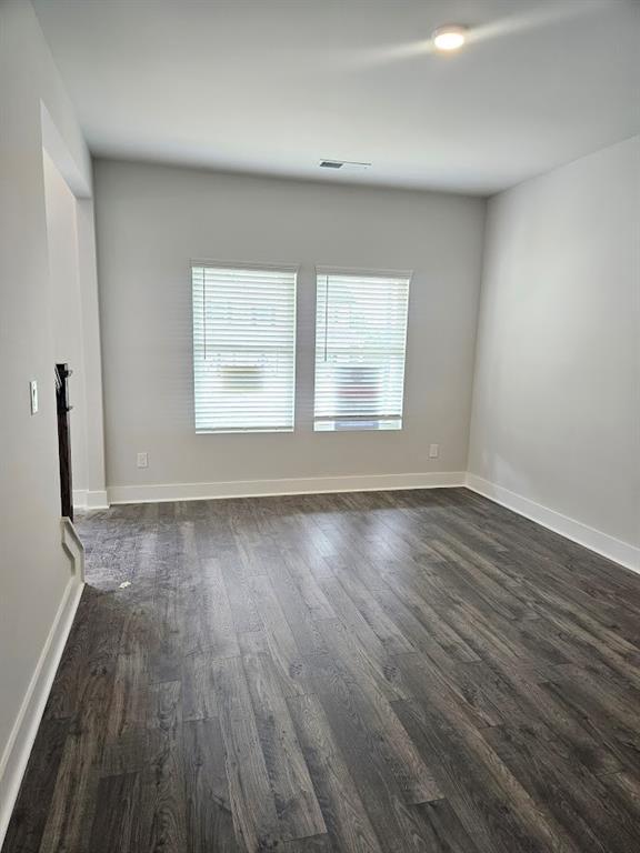 195 Silvercrest Dr, Acworth, GA 30101 - empty room featuring plenty of natural light, dark wood-style flooring, and baseboards