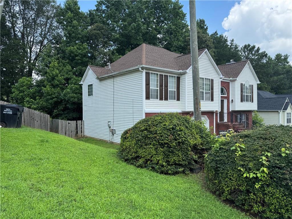 4192 Rhinehart Dr, Austell, GA 30106 - view of home's exterior with brick siding and view of wooded area