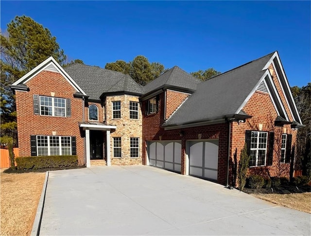 view of front of house featuring a garage, brick siding, driveway, and roof with shingles