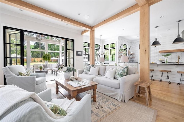 living area featuring recessed lighting, beam ceiling, and wood finished floors