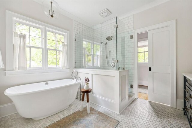 full bath featuring a soaking tub and a shower stall