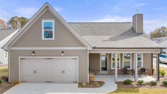 view of front of home featuring a garage and a porch