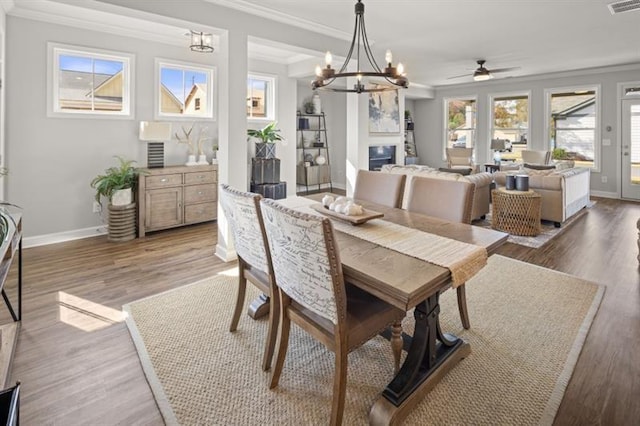 dining room featuring crown molding, ceiling fan, and dark hardwood / wood-style floors