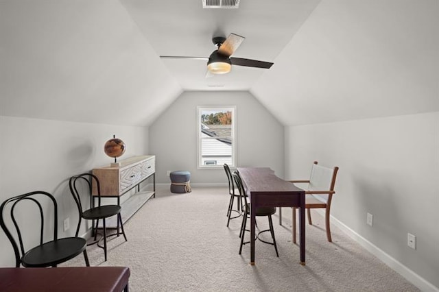 carpeted dining area featuring vaulted ceiling and ceiling fan