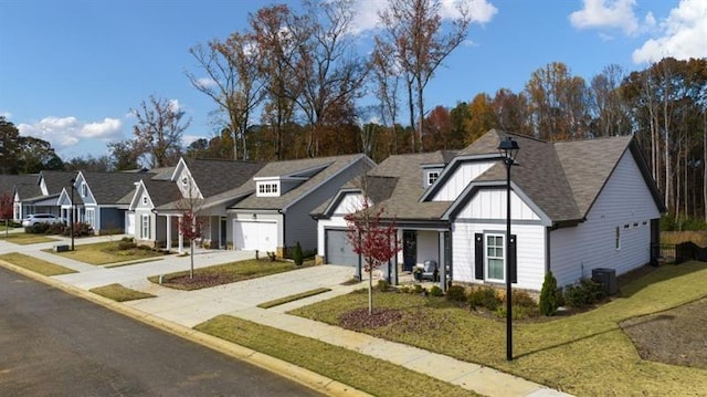 view of front of property with cooling unit, a garage, and a front lawn