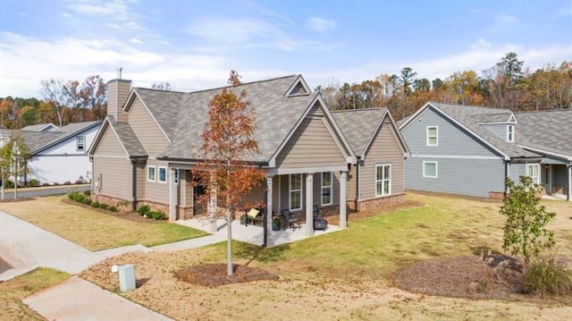 back of property featuring a patio and a yard