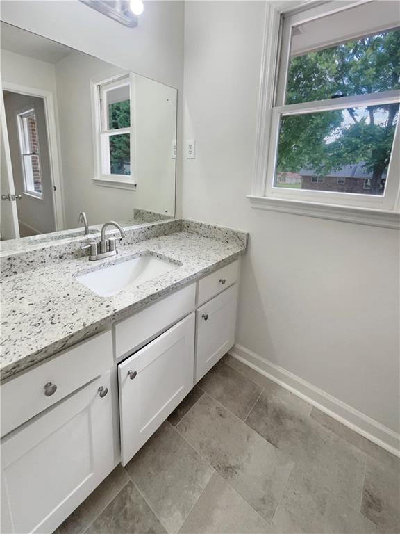 1710 Fontaine Dr, Jonesboro, GA 30236 - bathroom with vanity, healthy amount of natural light, and baseboards