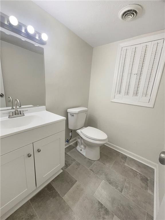 1710 Fontaine Dr, Jonesboro, GA 30236 - bathroom with vanity, toilet, and baseboards