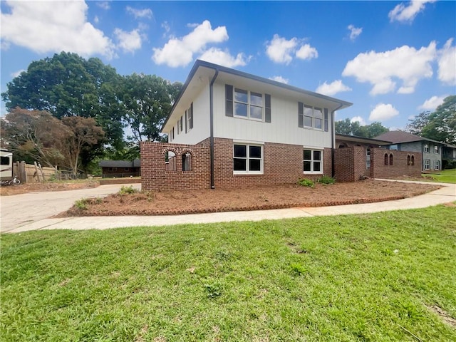 1710 Fontaine Dr, Jonesboro, GA 30236 - view of front of property with a front lawn, concrete driveway, and brick siding