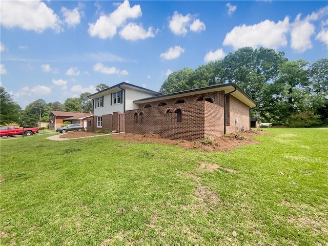 1710 Fontaine Dr, Jonesboro, GA 30236 - view of property exterior with brick siding and a yard