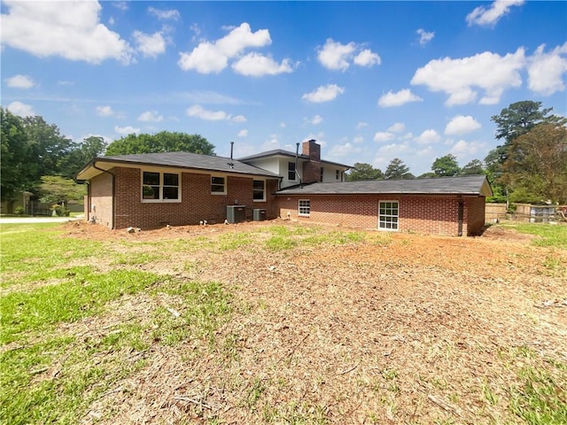 1710 Fontaine Dr, Jonesboro, GA 30236 - back of house featuring brick siding, central AC unit, and a chimney