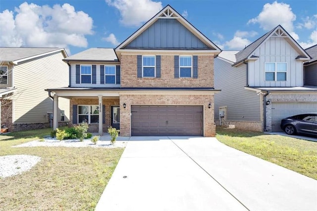 2375 Walker Dr, Hampton, GA 30228 - craftsman-style home with board and batten siding, a front lawn, brick siding, an attached garage, and concrete driveway