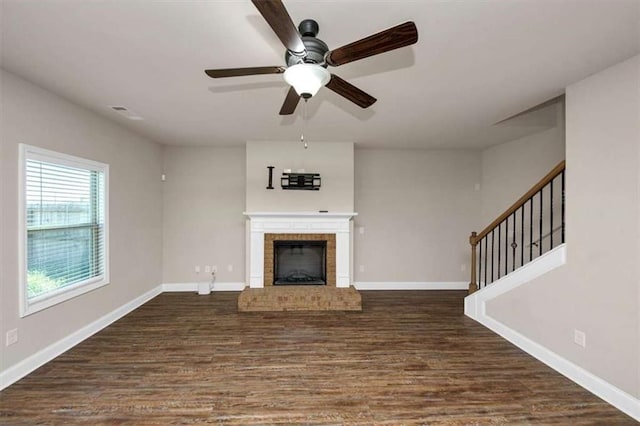 2375 Walker Dr, Hampton, GA 30228 - unfurnished living room featuring baseboards, a ceiling fan, a fireplace, dark wood-style floors, and stairs