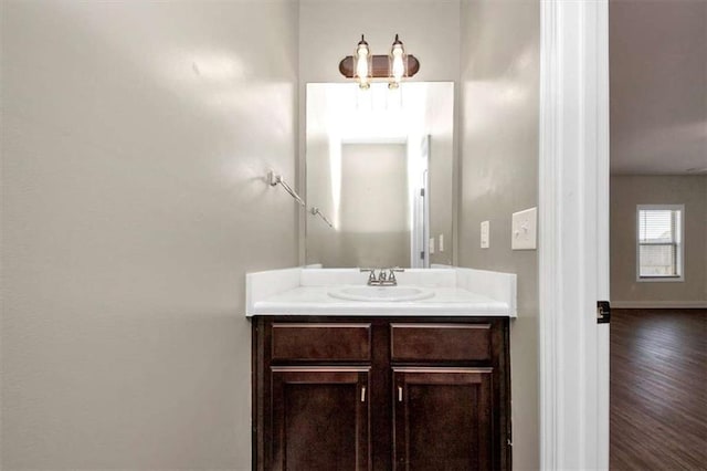 2375 Walker Dr, Hampton, GA 30228 - bathroom with vanity, baseboards, and wood finished floors