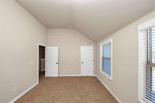 2375 Walker Dr, Hampton, GA 30228 - unfurnished bedroom with visible vents, baseboards, carpet floors, and lofted ceiling