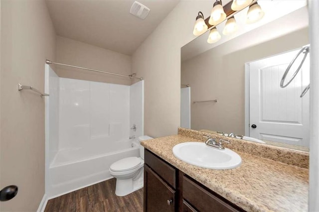 2375 Walker Dr, Hampton, GA 30228 - bathroom with shower / washtub combination, vanity, visible vents, toilet, and wood finished floors
