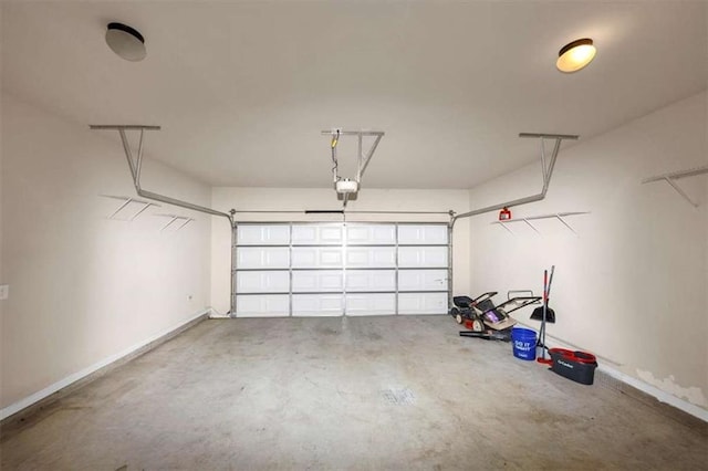 2375 Walker Dr, Hampton, GA 30228 - garage with baseboards and a garage door opener