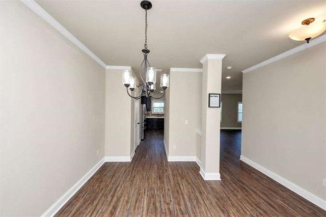 2375 Walker Dr, Hampton, GA 30228 - unfurnished dining area featuring dark wood-type flooring, baseboards, an inviting chandelier, and crown molding