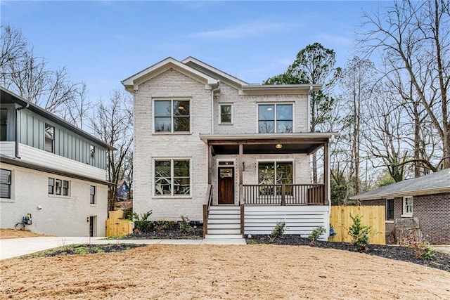 view of front of home featuring a porch and brick siding