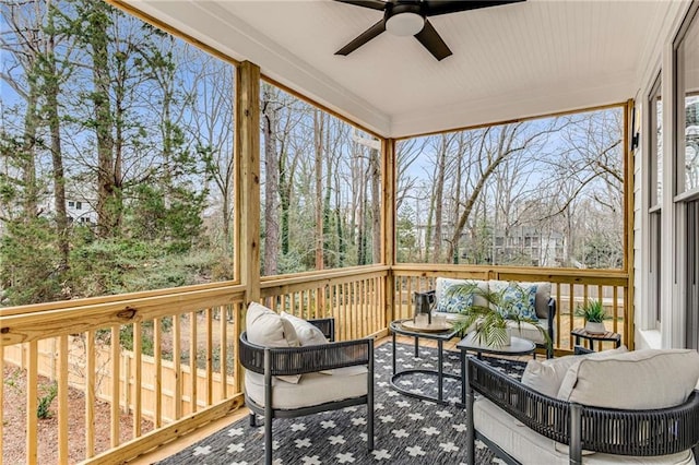 sunroom / solarium featuring ceiling fan