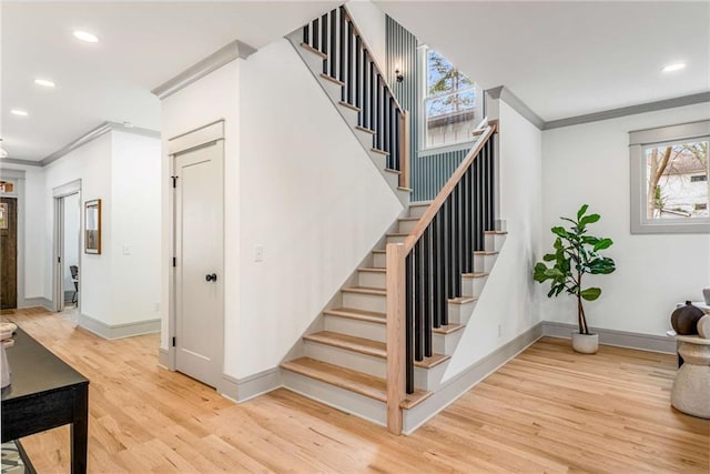 stairway featuring ornamental molding, recessed lighting, wood finished floors, and baseboards