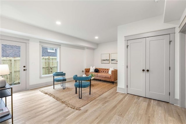 sitting room with baseboards, recessed lighting, and light wood-style floors