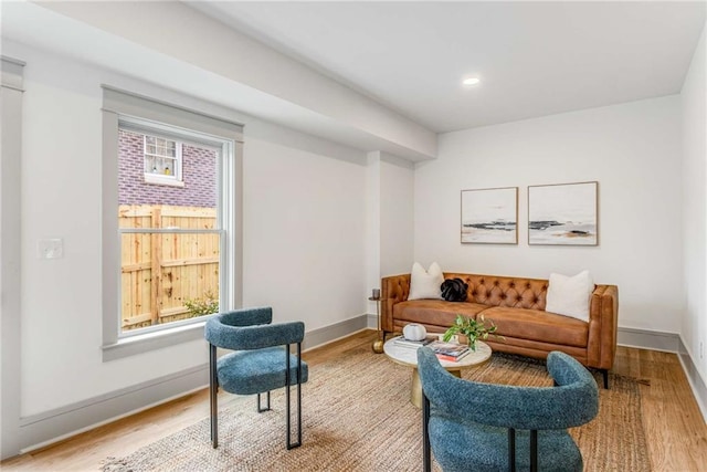 living room featuring recessed lighting, baseboards, and wood finished floors