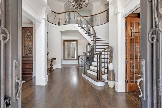 4317 Oglethorpe Loop NW, Acworth, GA 30101 - foyer entrance with stairs, ornamental molding, dark wood-type flooring, a chandelier, and a towering ceiling
