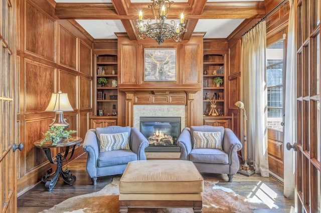4317 Oglethorpe Loop NW, Acworth, GA 30101 - sitting room with built in features, a chandelier, wood finished floors, wooden walls, and a premium fireplace