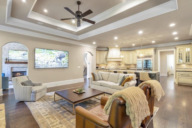 4317 Oglethorpe Loop NW, Acworth, GA 30101 - living room featuring a ceiling fan, crown molding, arched walkways, dark wood-style floors, and recessed lighting