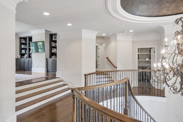 4317 Oglethorpe Loop NW, Acworth, GA 30101 - hall with crown molding, wood finished floors, recessed lighting, built in features, and a chandelier