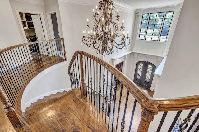 4317 Oglethorpe Loop NW, Acworth, GA 30101 - stairway with a high ceiling, a chandelier, washer / dryer, and crown molding