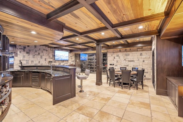 4317 Oglethorpe Loop NW, Acworth, GA 30101 - kitchen featuring a wood ceiling with exposed beams, decorative columns, a kitchen bar, a peninsula, and recessed lighting