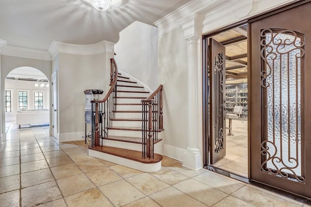 4317 Oglethorpe Loop NW, Acworth, GA 30101 - entrance foyer with crown molding, arched walkways, stairway, and stone tile flooring